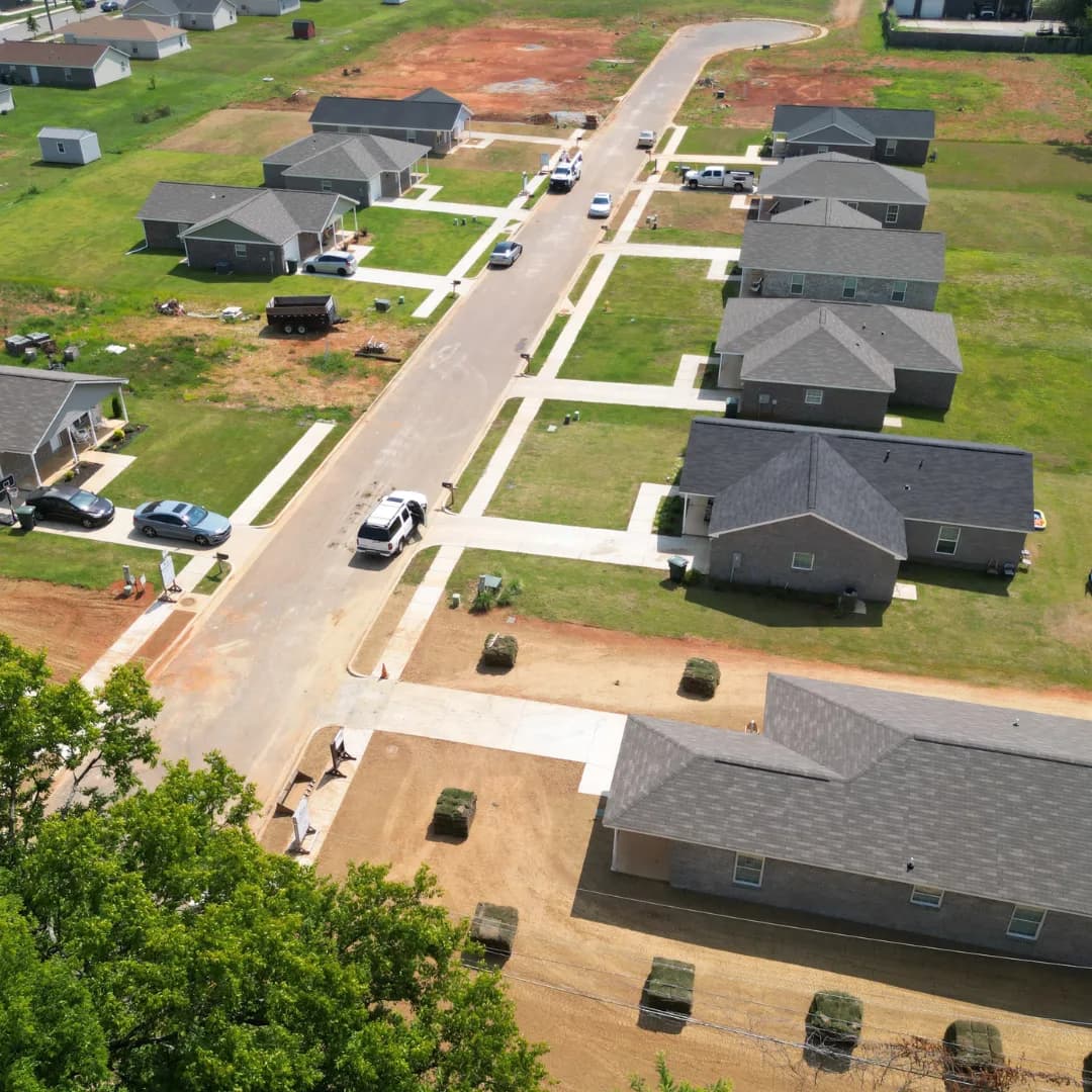 An aerial view of prepared residential yards with sod rolls ready for installation